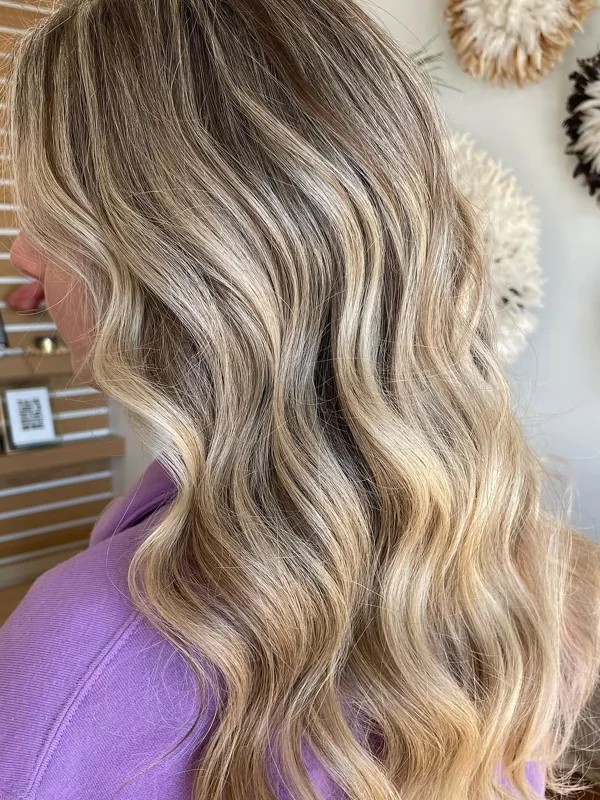 Bright, traditional blonde highlights through long waves, by Amy Kurtz